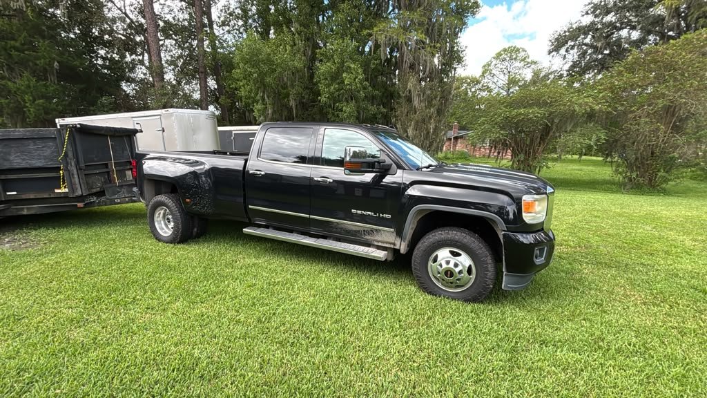 Black Haulmark trailer and utility trailer side by side