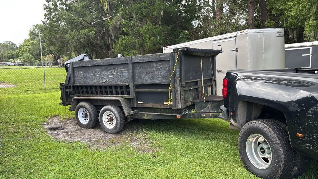 Loaded dump trailer with junk appliances